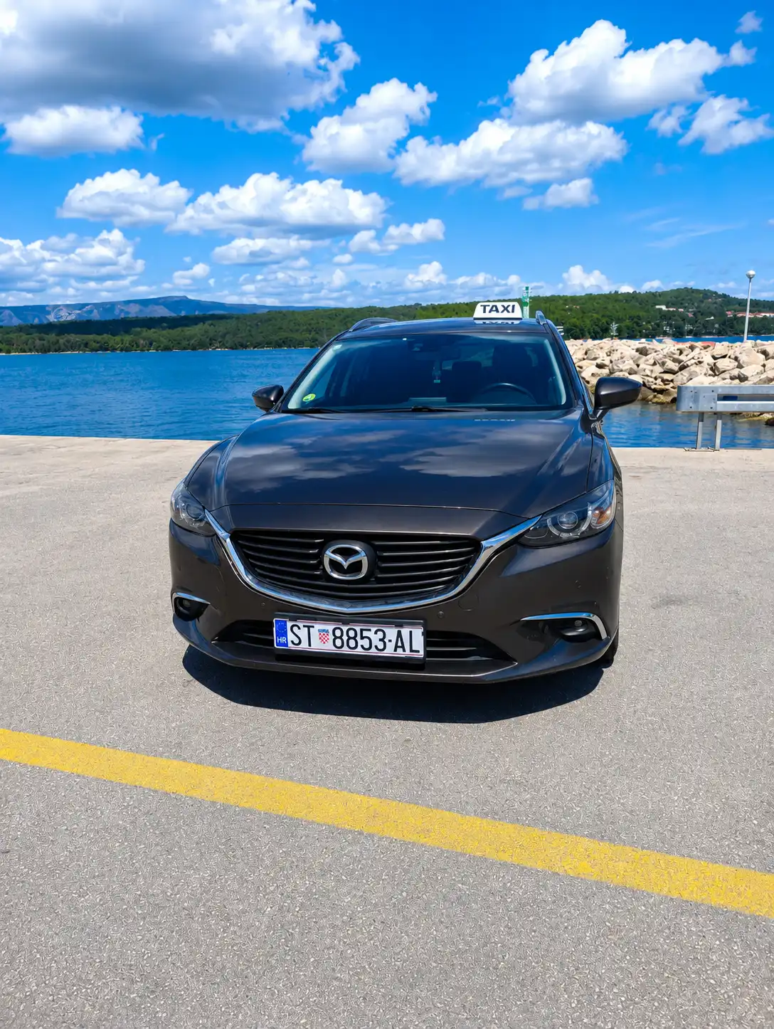 Taxi Hvar sedan front view by the sea